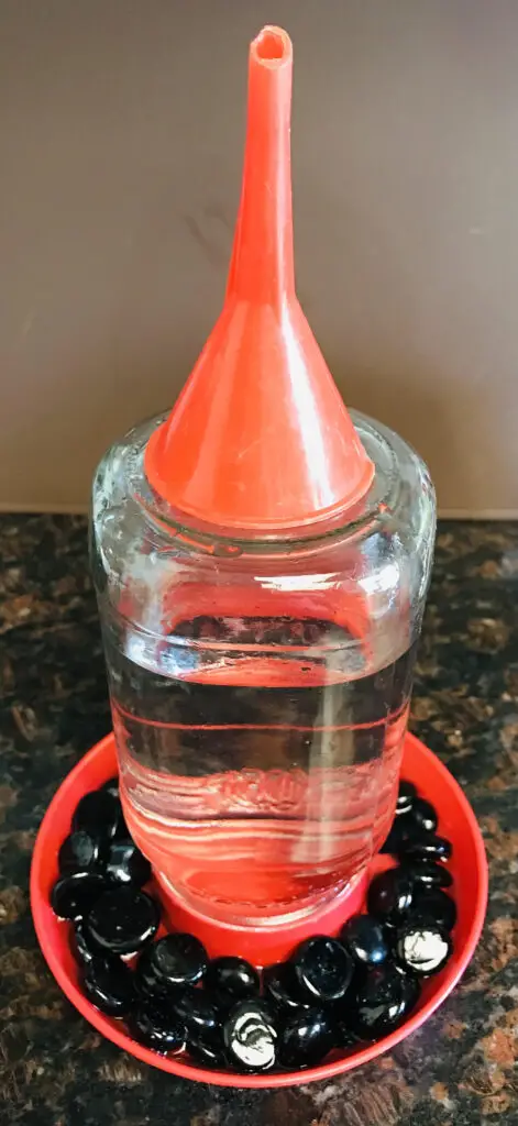 Chick-Waterer-with-Funnel-on-Top - Dollar Store Chicken Supplies. (How to keep chicken water clean.)