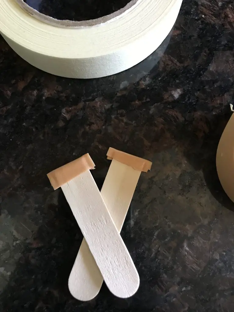 COVER THE SHARP ENDS OF THE SPLINTING STICKS WITH SOFT, SELF-ADHESIVE TAPE.