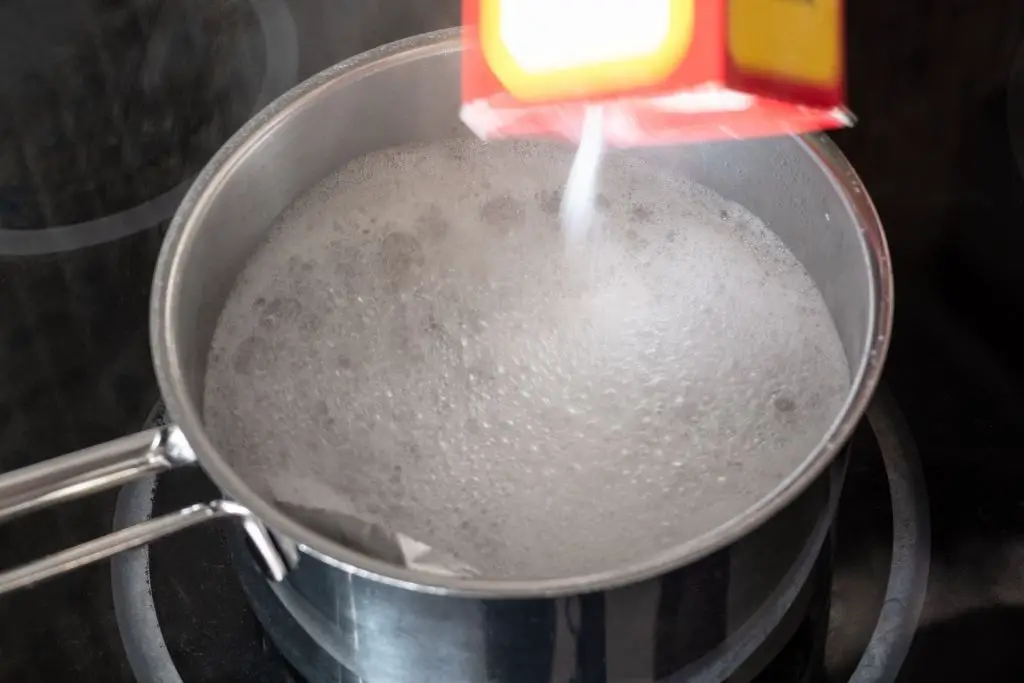 ADD BAKING SODA TO BOILING WATER TO HELP RAISE THE pH INSIDE THE EGG.